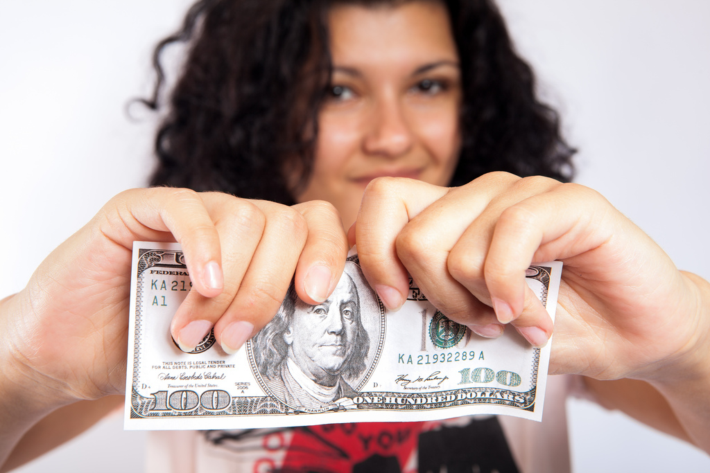 girl tearing dollar